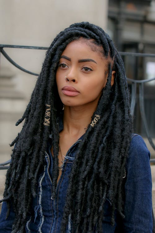 Woman in Blue Denim Jacket with Dreadlocks