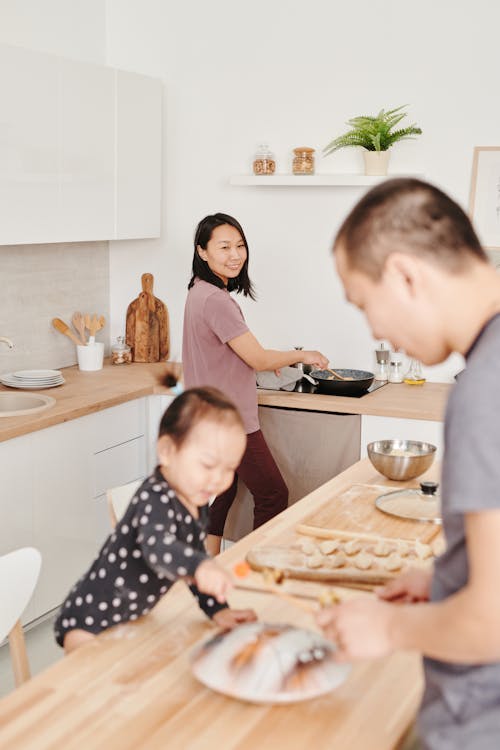 Free Photo of a Mother Cooking while Smiling Stock Photo