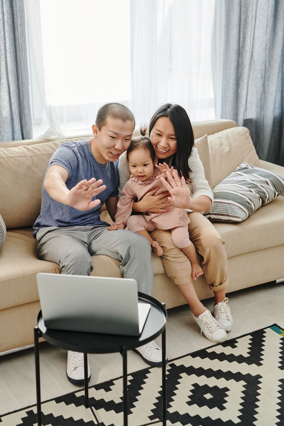Family waving to a laptop video call