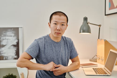A Man Sitting in front of His Laptop