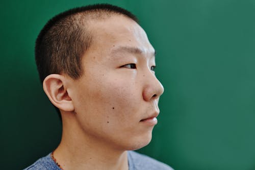 A Man with Short Hair with a Green Background