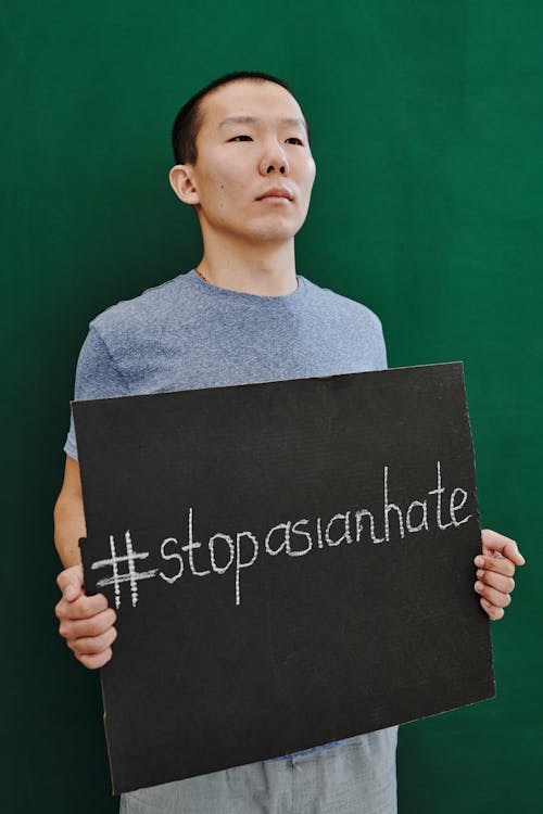 Free Photograph of a Man Holding a Signage with a Message Stock Photo