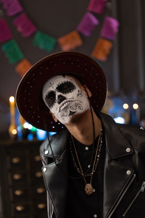 Free A person with artistic face paint celebrates Dia de los Muertos indoors. Stock Photo