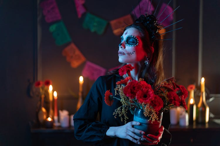 A Woman Holding A Bunch Of Flowers