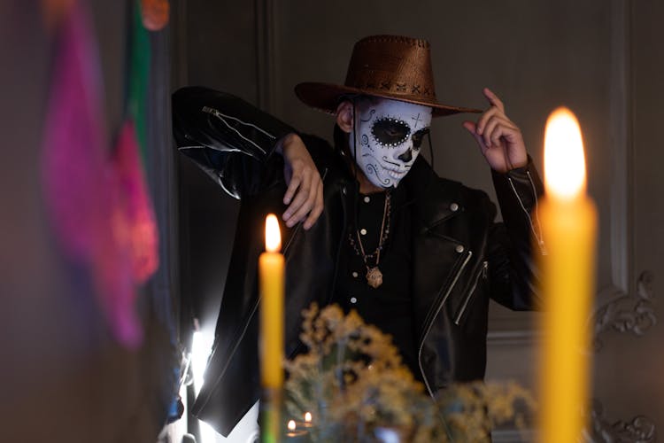 A Man In A Leather Jacket And A Hat