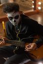 Man in Black Jacket Playing Electric Guitar