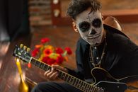 Man in Black Shirt Playing Guitar