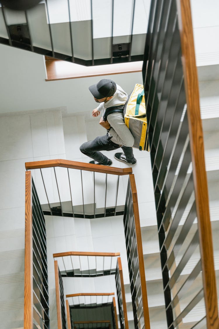 Deliveryman Going Up The Stairs