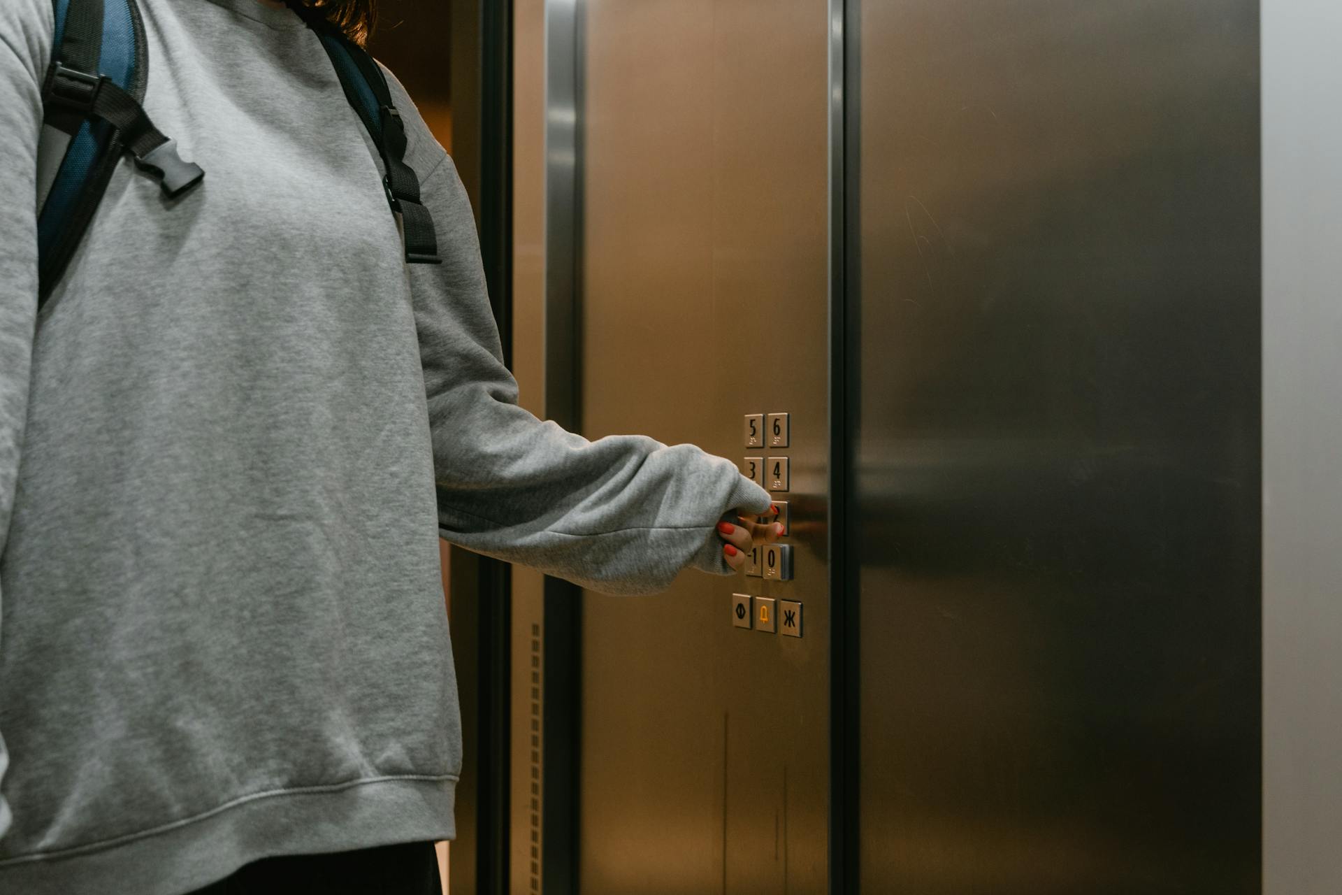 Person Pressing the Elevator Button