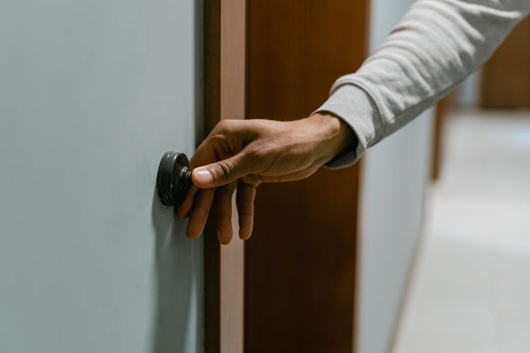 Person Ringing The Doorbell