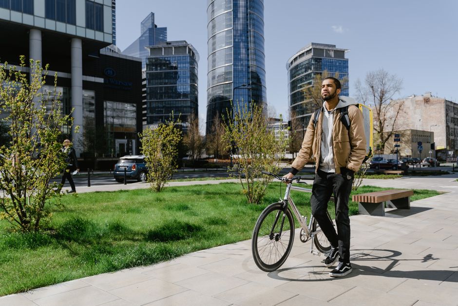 Bicycle courier in Warsaw urban area, navigating city streets for fast delivery.