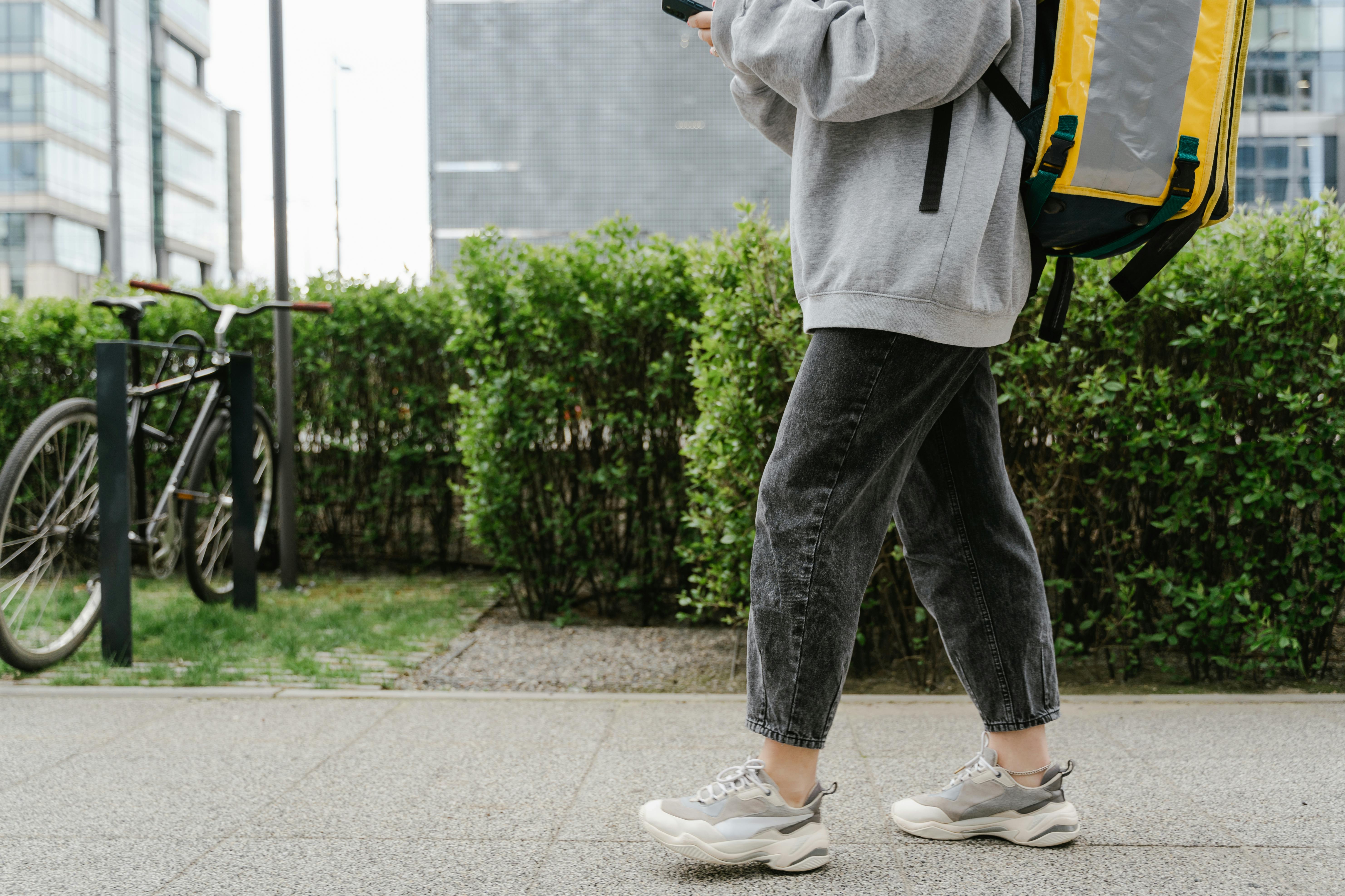 Deliveryman Walking on the Sidewalk · Free Stock Photo