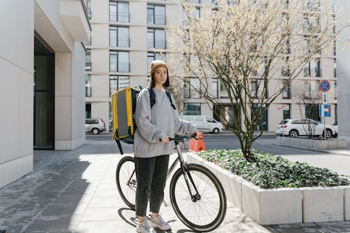 Free Woman Holding her Bicycle Stock Photo