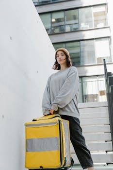 A woman delivering food in the city, showcasing a modern urban lifestyle.
