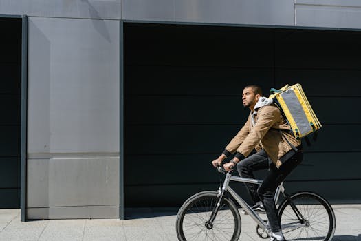 A food delivery courier biking through urban streets, carrying a delivery bag.
