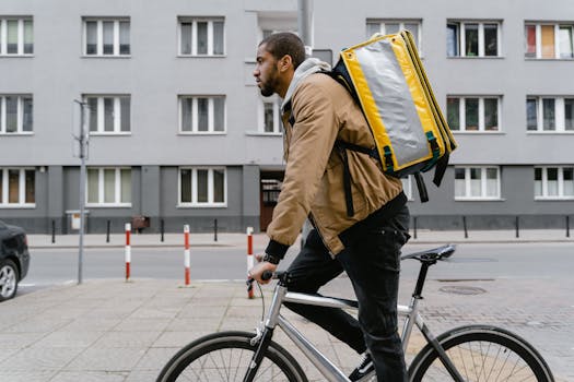 Bicycle courier in Warsaw carrying a delivery bag through urban streets, representing modern transportation.