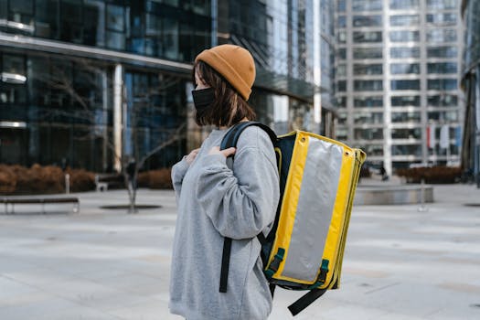 A person with a thermal backpack delivering food in an urban environment.