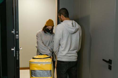 Man and Woman Standing by the Door