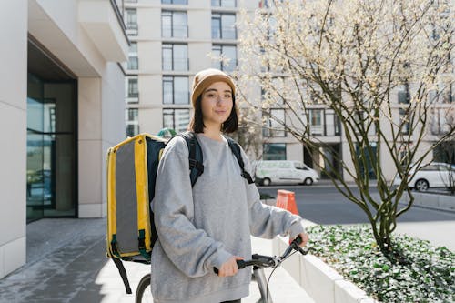 Woman Standing Beside her Bicycle