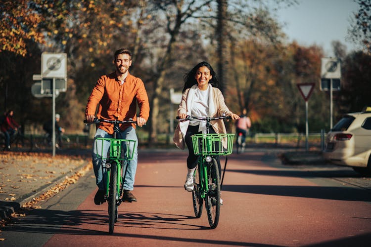 Smiling Woman And Man On Bicycles