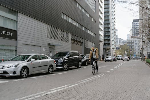 A courier on a bike delivering food in a bustling city street, showcasing modern urban logistics.