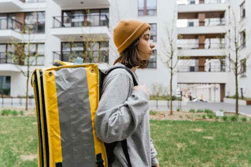 Free Woman Carrying a Yellow Bag Stock Photo