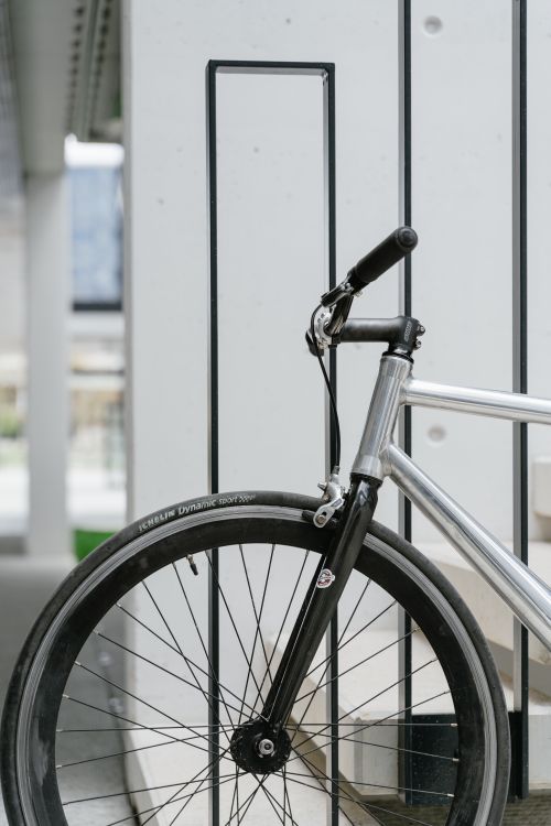 Free Close-up of a bicycle against a modern urban backdrop. Stock Photo