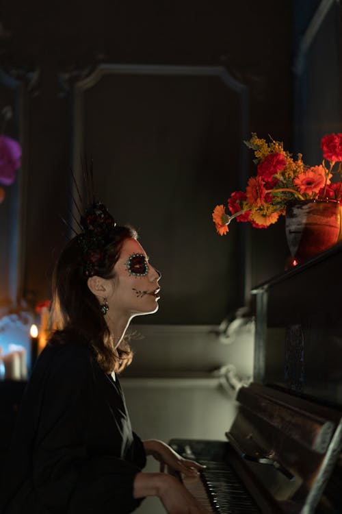 A Woman with Face Paint Playing the Piano