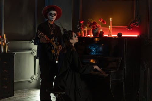 Man and Woman in Halloween Costumes with Musical Instruments