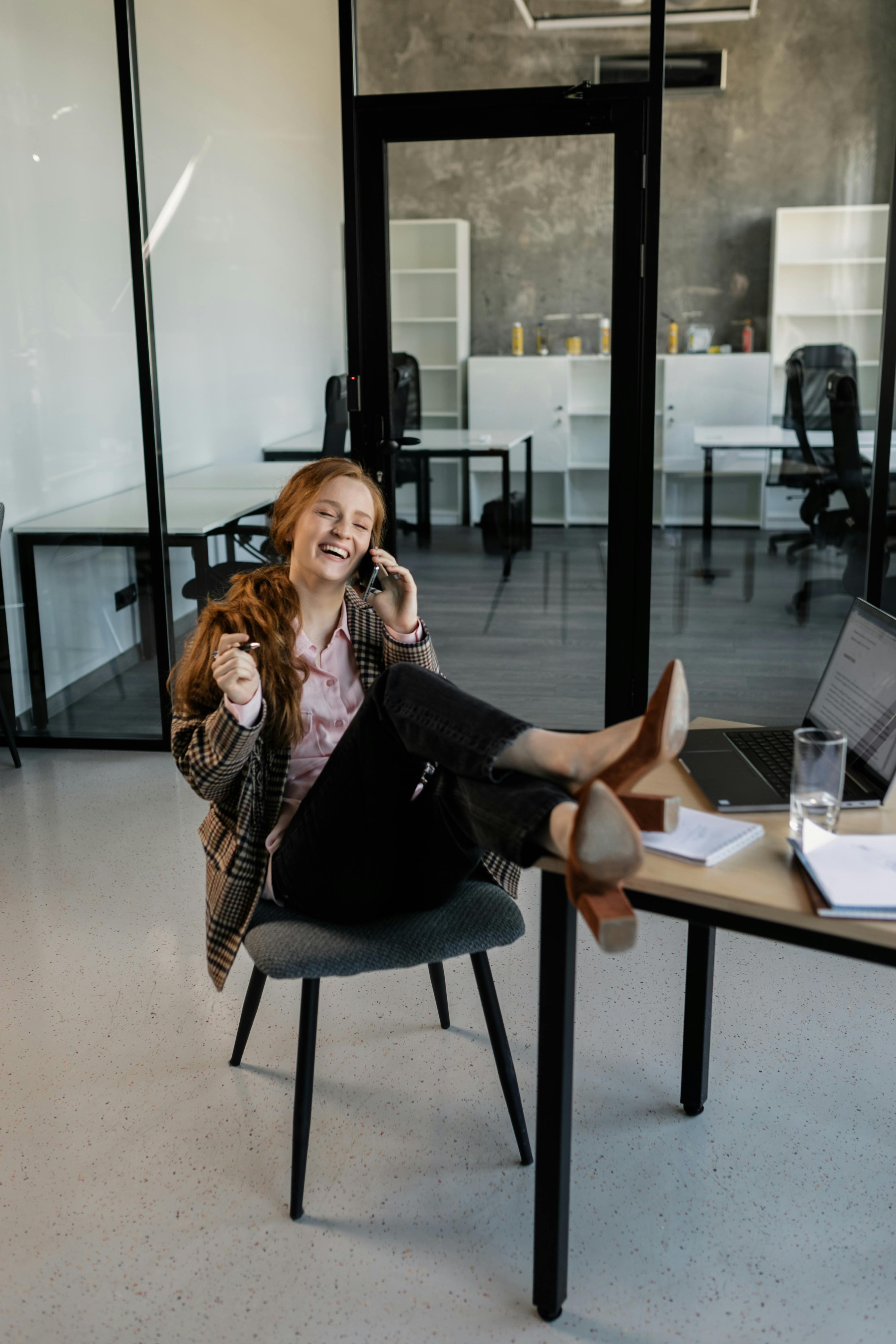 a woman having a phone call in the office