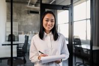 Woman in White Dress Shirt Holding White Tablet Computer