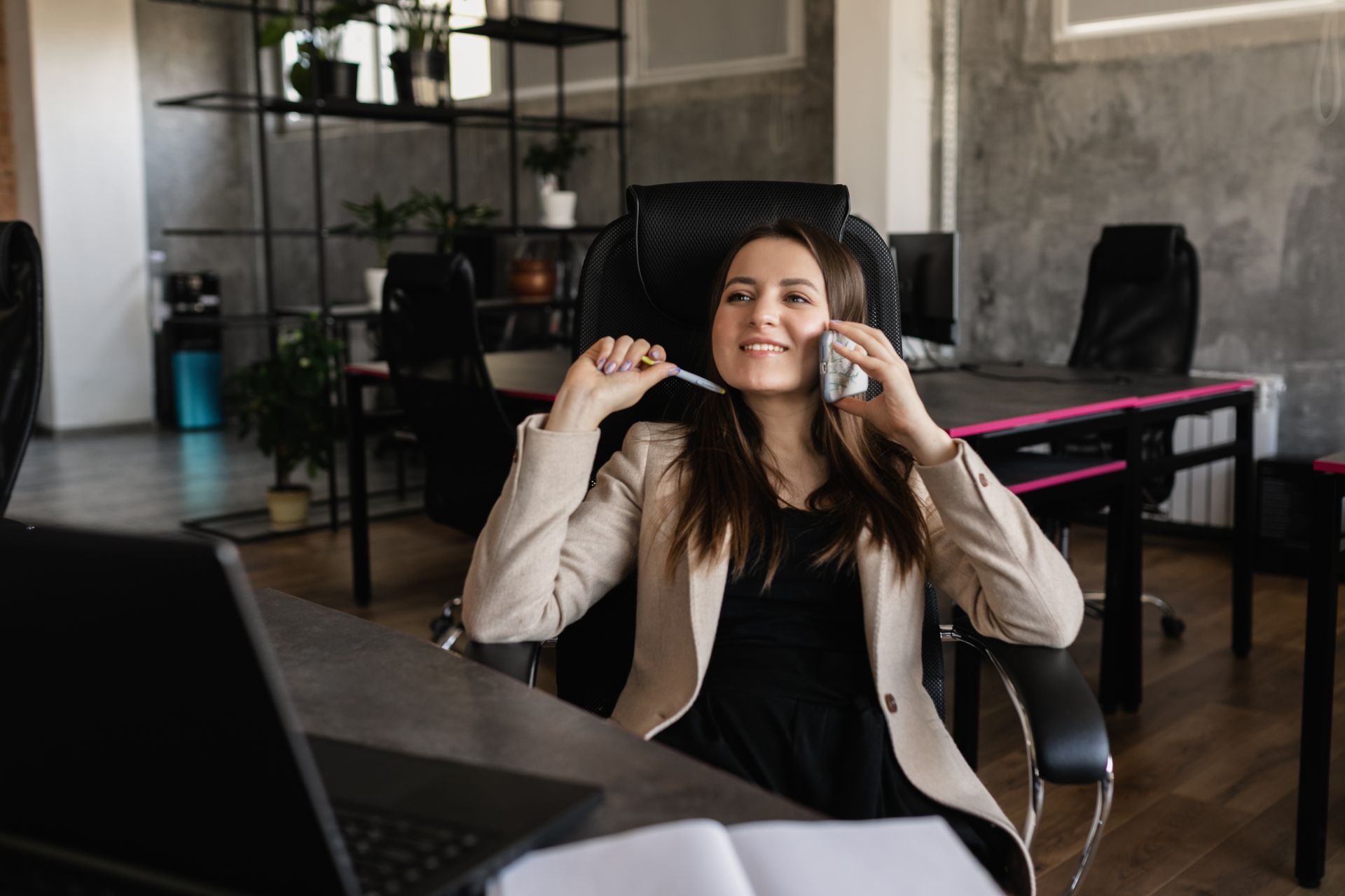 Photo of a Woman Talking on the Phone while Smiling