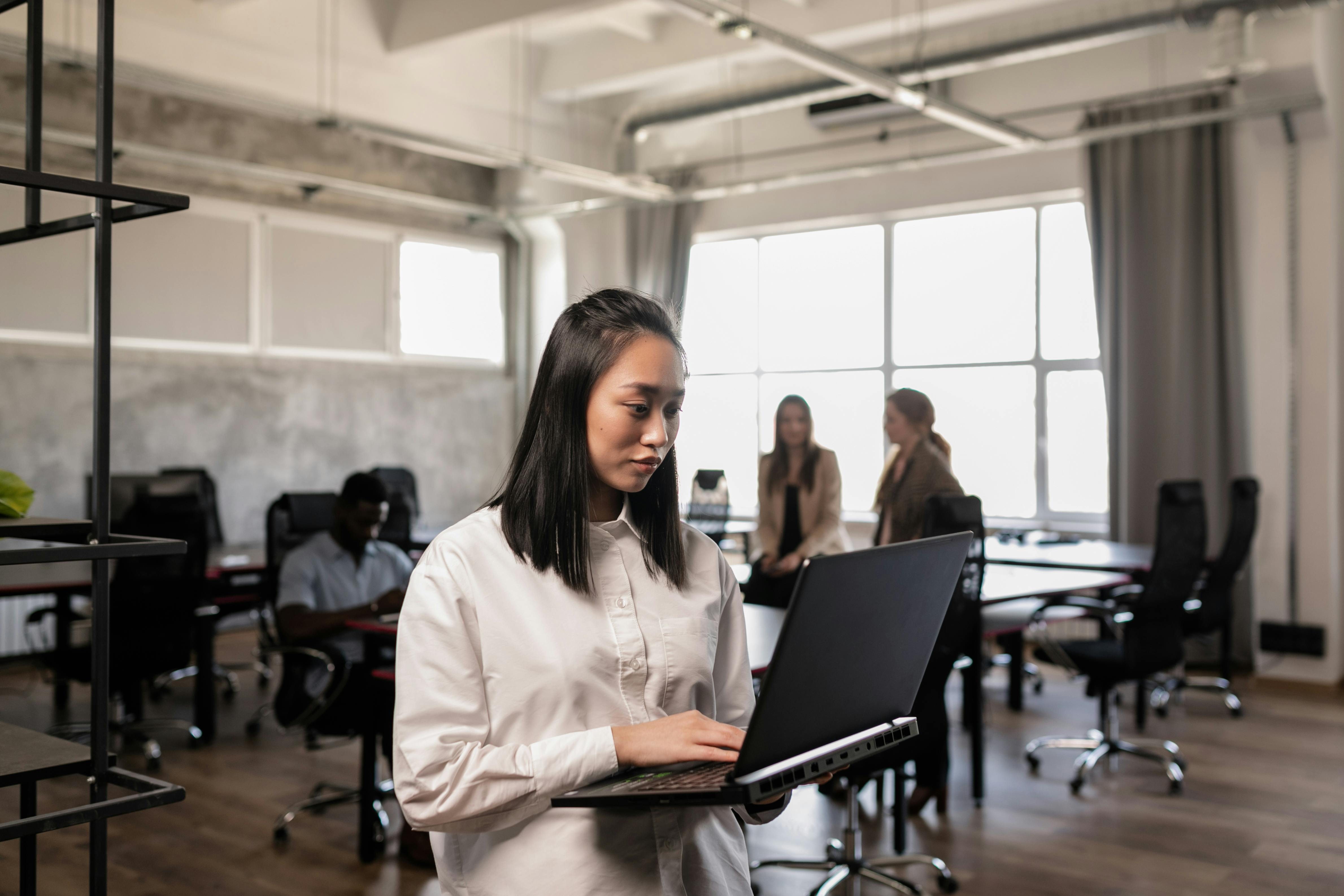 a woman holding a laptop