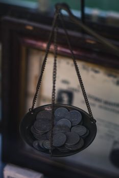 A person comparing market charts with astrology symbols to avoid risks in astrology for investment decisions.