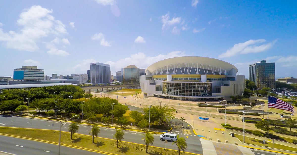 Christ Embassy Loveworld Arena Ho exterior view with sign and palm trees