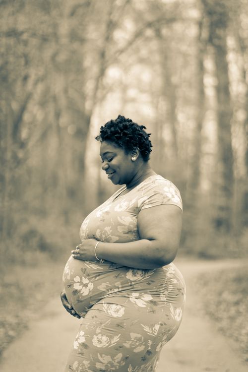 Expectant Black mother taking a peaceful moment outdoors