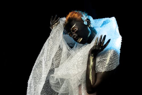 Woman with dark body art and bubble wrap