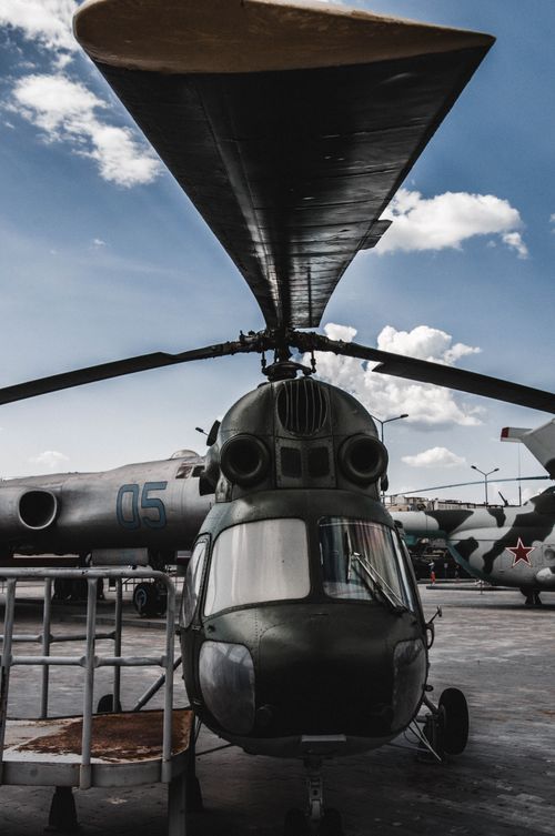 Free Close-up of a military helicopter under blue sky, showcasing aviation details. Stock Photo