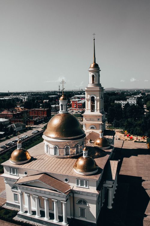 Free Stunning aerial view of a golden domed cathedral surrounded by a vibrant cityscape. Stock Photo