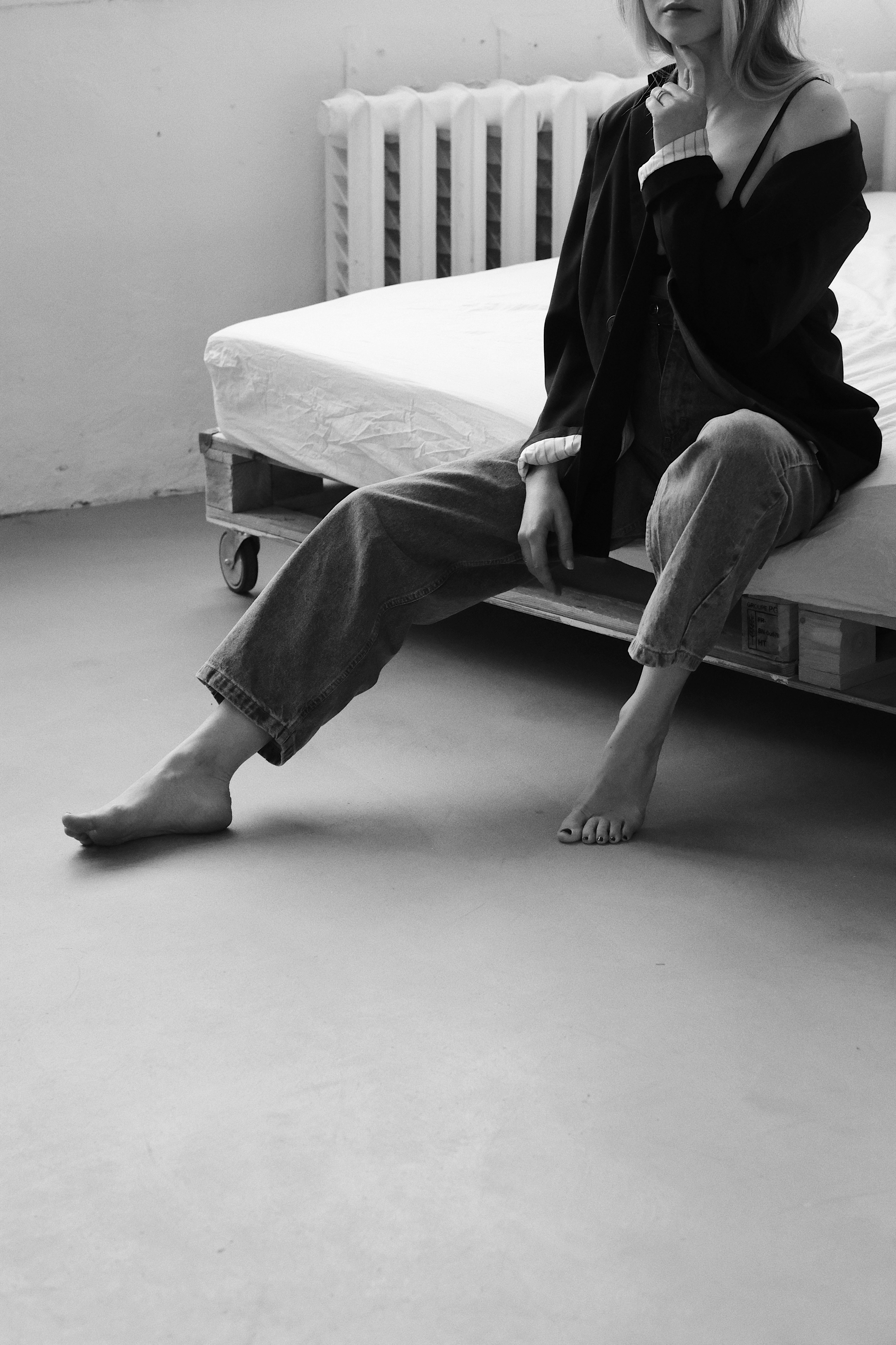 Man in Black Jacket Sitting on Bed