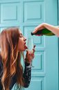 Photograph of a Woman Licking Champagne on a Glass