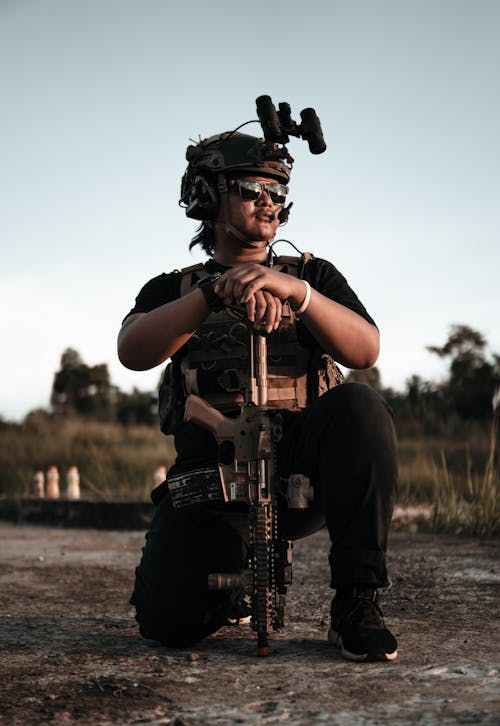 Photo of a Man with a Rifle Looking Away