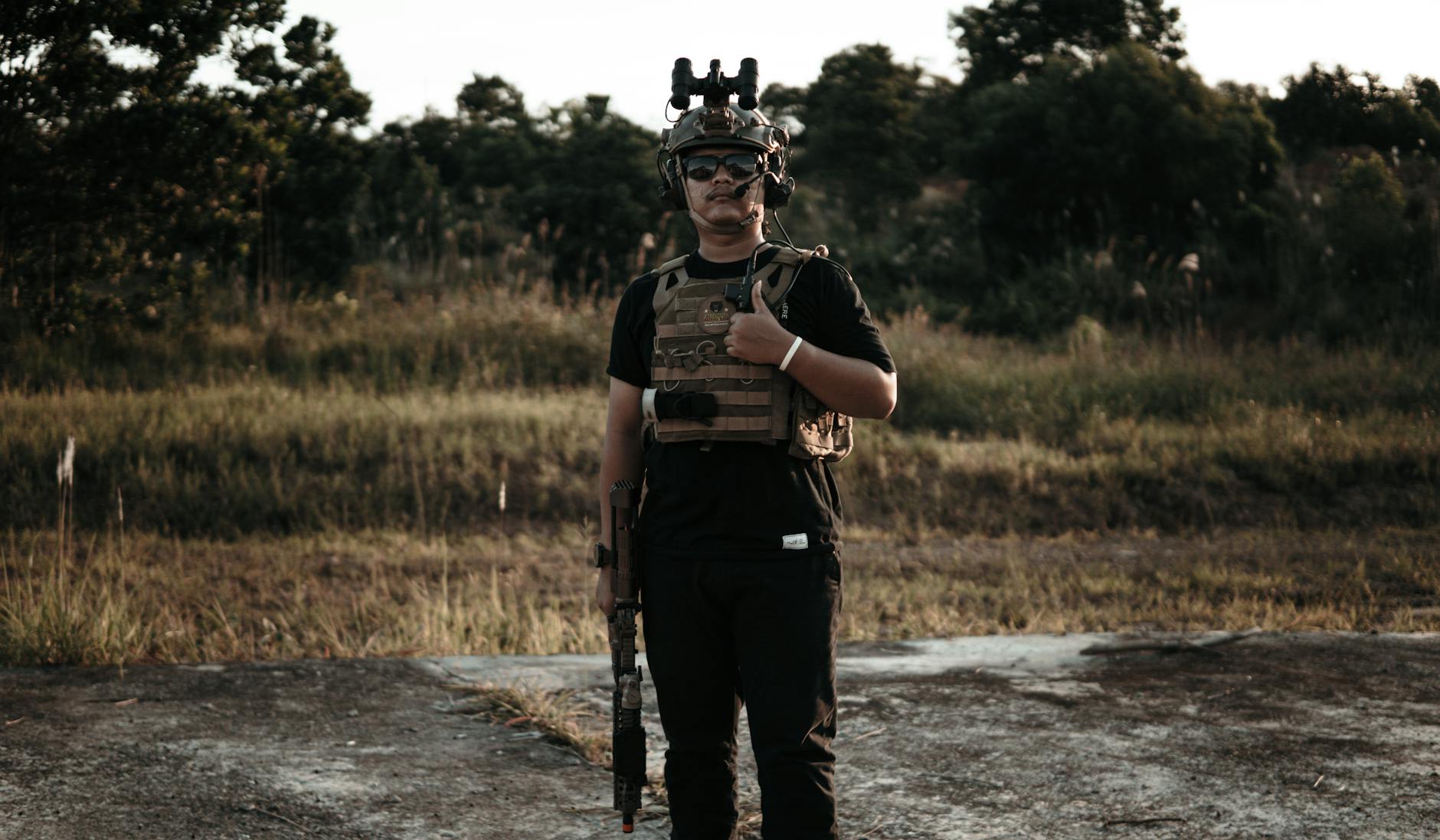 Photo of a Man with a Bulletproof Vest Doing a Thumbs Up