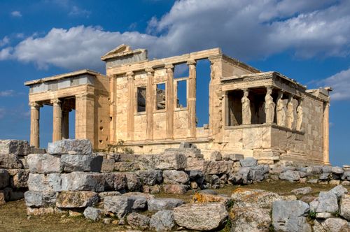 Free The Erechtheion temple at Acropolis in Athens, showcasing ancient Greek architecture under a clear blue sky. Stock Photo