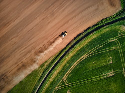 Drone Shot of a Tractor on a Field