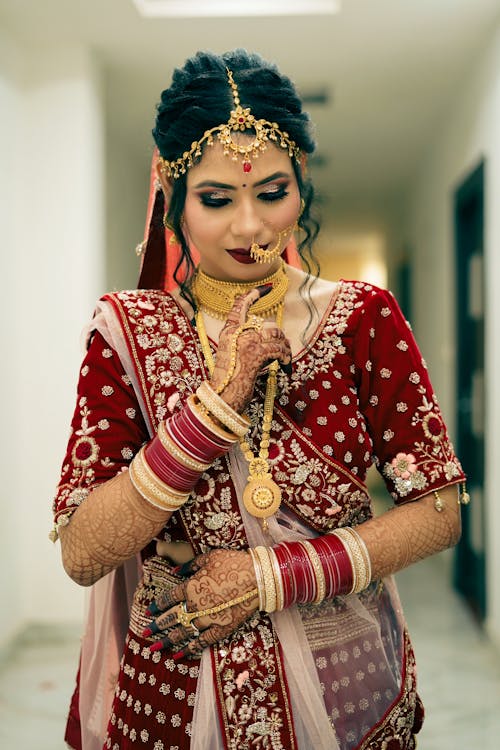 Free Portrait of a Bride in Gold and Red Traditional Wear Stock Photo