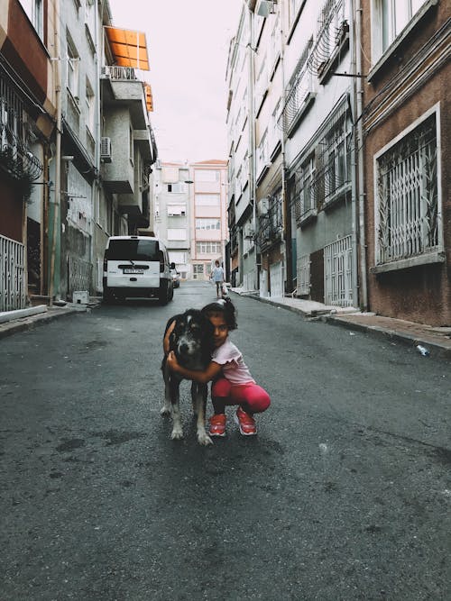 A Girl Hugging a Dog