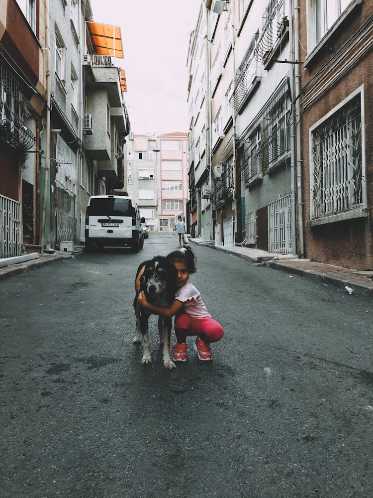 A Girl Hugging A Dog