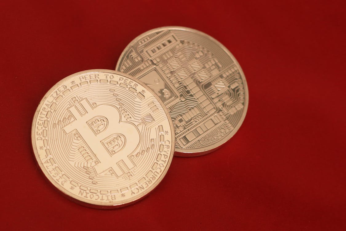 Free Photo of Two Coins on a Red Surface Stock Photo