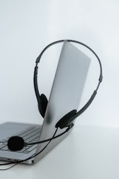 A sleek laptop with a headset, ideal for remote work or online communication.